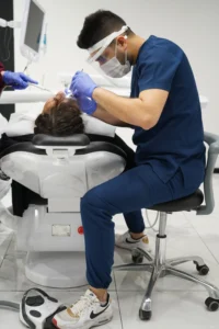 Dentist checking a restoration in a patient's mouth during a seat appointment